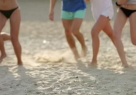 young people playing on the beach