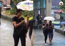 Young lady shelters strangers to and fro Raffles Place MRT Station during heavy downpour